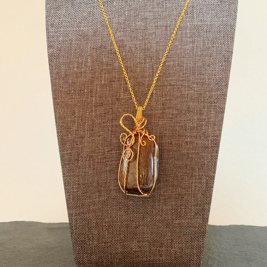 Pendant made of Bronzite rectangular stone with gold wire wrap; 1 1/8" w x 2.5" h incl bail