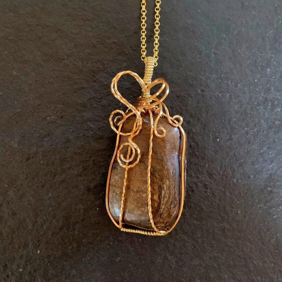 Pendant made of Bronzite rectangular stone with gold wire wrap; 1 1/8" w x 2.5" h incl bail