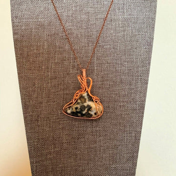 Pendant made of Ocean jasper triangular stone with copper wrap; 1.5" w x 1 7/8" h incl bail