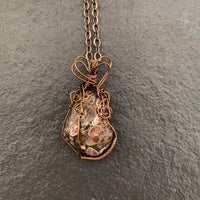 Pendant made of Turitella Agate with bronze wrap; 1.1" w x 2" h incl bail