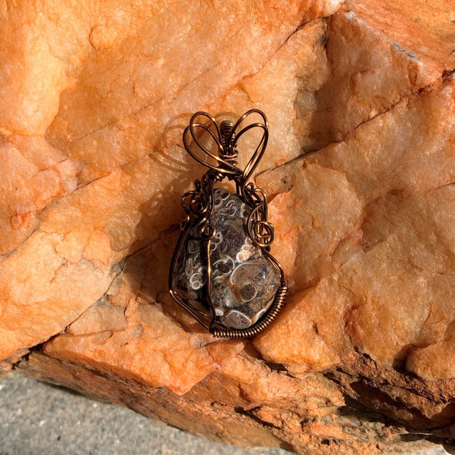 Pendant made of Turitella Agate with bronze wrap; 1.1" w x 2" h incl bail