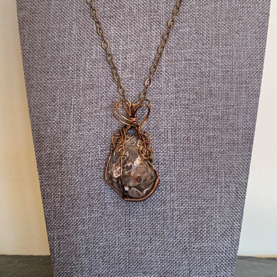 Pendant made of Turitella Agate with bronze wrap; 1.1" w x 2" h incl bail