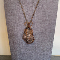 Pendant made of Turitella Agate with bronze wrap; 1.1" w x 2" h incl bail