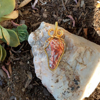 Pendant made of Leopard Skin Jasper triangular stone with gold wrap; 1" w x 2 3/8" H incl bail