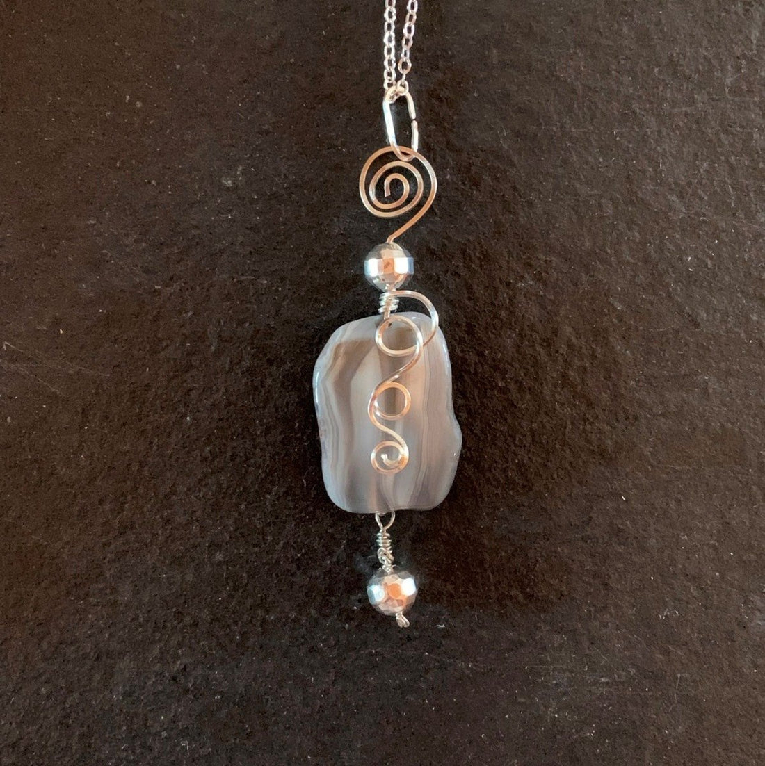 Pendant made of Grey botswana Agate nugget with silver wrap; 1" w x 3.5" h incl bail