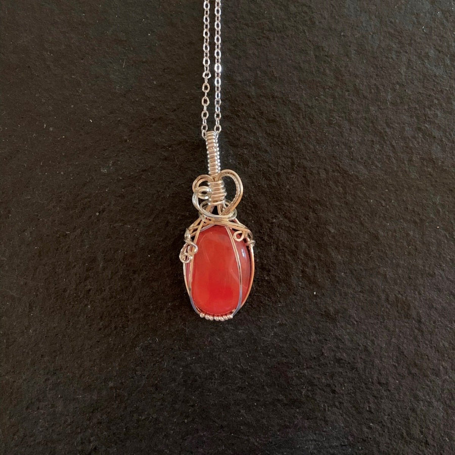 Pendant made of Cherry Quartz oval with silver wrap; 7/8" w x 2" H incl bail