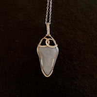Pendant made of Blue Lace Agate with silver wrap; 1" w x 2 3/8" h incl bail