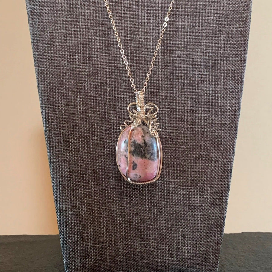 Pendant made of Pink & Grey Rhodonite oval stone with silver wrap; 1" w x 2" h incl bail