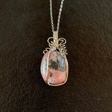 Pendant made of Pink & Grey Rhodonite oval stone with silver wrap; 1" w x 2" h incl bail