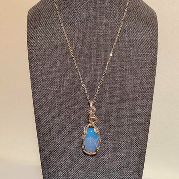 Pendant made of Oval Moonstone with silver wrap; 3/4" W x 2" H incl bail