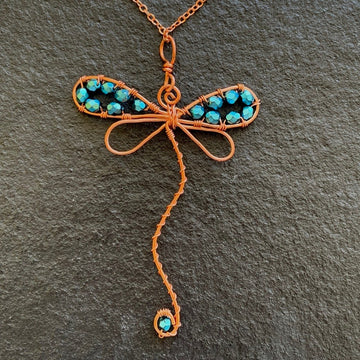 Pendant made of Dragonfly shaped copper wire with turquoise crystals; 2 1/8" w x 3 3/8" h incl bail