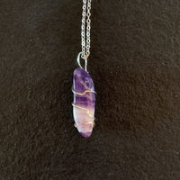 Pendant made of Chevron Amethyst long nugget with silver wrap; 1/2" w x 1 7/8" h, incl bail