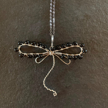 Pendant made of Dragonfly shaped wire with black seed beads; 3" w x 2.5" h, incl bail