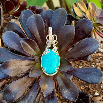 Pendant made of Turquoise Dyed Magnesite with silver wrap.75" w x 2" h, incl bail