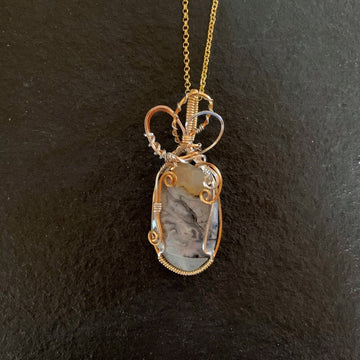 Pendant made of Crazy Lace Agate with gold & silver wrap; 1" w x 2 3/8" h, incl bail