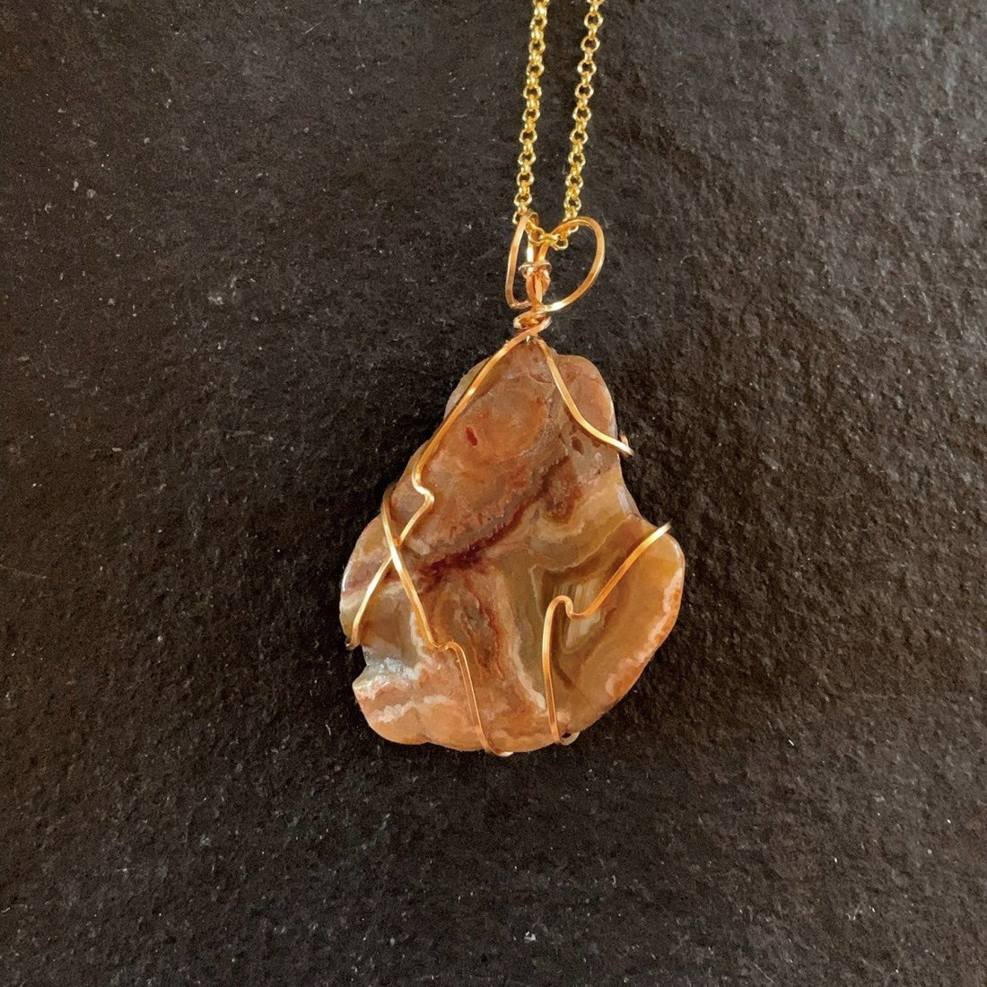 Pendant made of Banded Agate slice stone with simple gold wrap; 1.5" w x 2 3/8" h incl bail