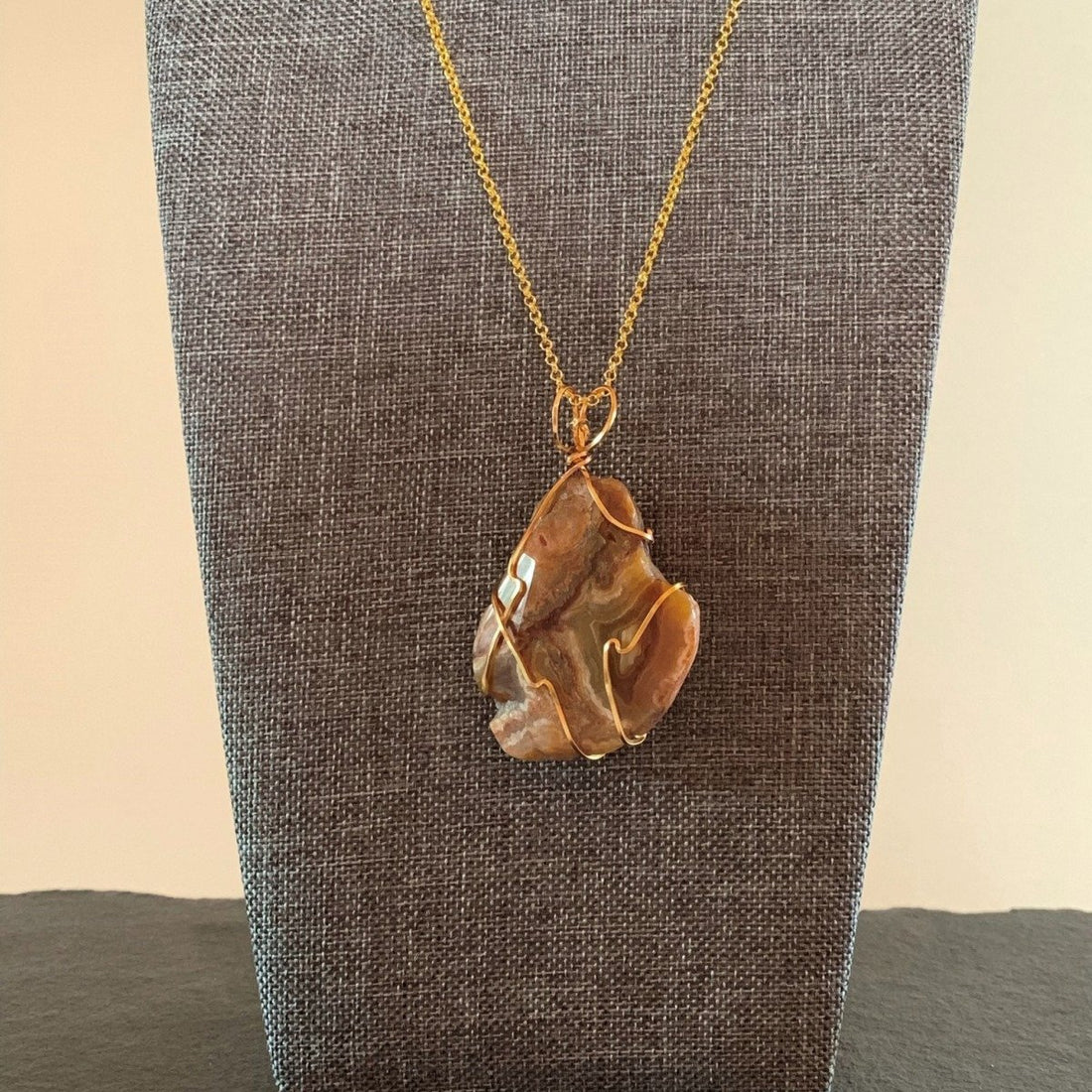 Pendant made of Banded Agate slice stone with simple gold wrap; 1.5" w x 2 3/8" h incl bail