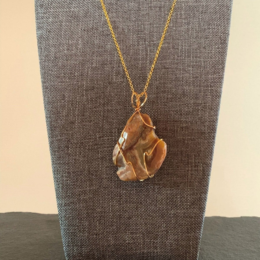 Pendant made of Banded Agate slice stone with simple gold wrap; 1.5" w x 2 3/8" h incl bail