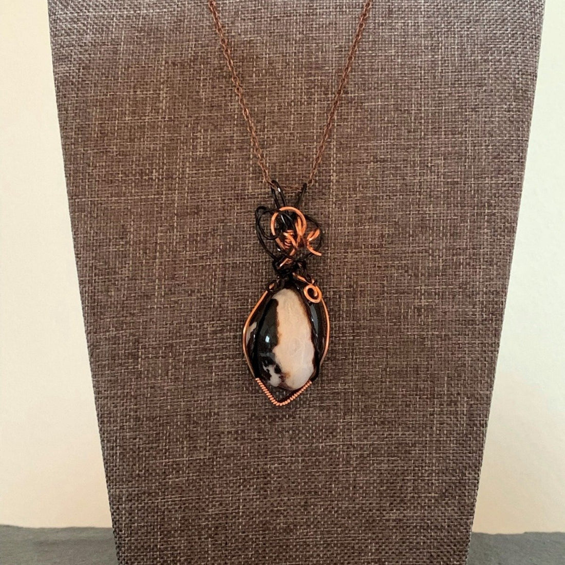 Pendant made of Black & White agate with black & copper wrap; 7/8" W X 2 3/8" H INCL BAIL