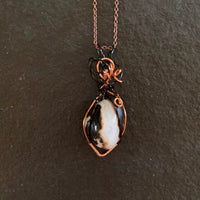 Pendant made of Black & White agate with black & copper wrap; 7/8" W X 2 3/8" H INCL BAIL