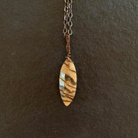 Pendant made of Fancy Jasper vase stone with simple bronze wrap; 5/8" W X 2.5" H INCL BAIL