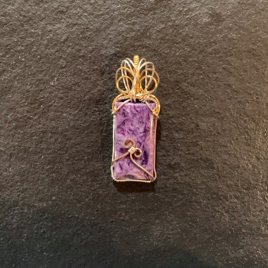 Pendant made of Charoite Rectangle Stone with gold & silver wrap; 1" w x 2 5/8" h, incl bail