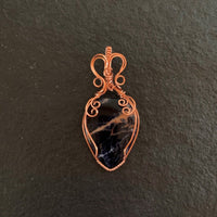 Pendant made of Sunset Sodalite teadrop with copper wrap; 1.25" w x 2 5/8" h, incl bail