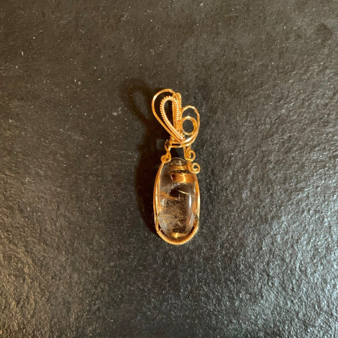 Pendant made of Golden Rutilated Quartz with gold wrap; .75" w x 2 3/8" h, incl bail