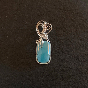 Pendant made of Larimar rectangular stone with silver wrap; .75" w x 2 1/8" h, incl bail