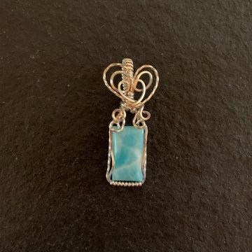 Pendant made of Larimar rectangular stone with silver wrap; .5" w x 1 7/8" h, incl bail