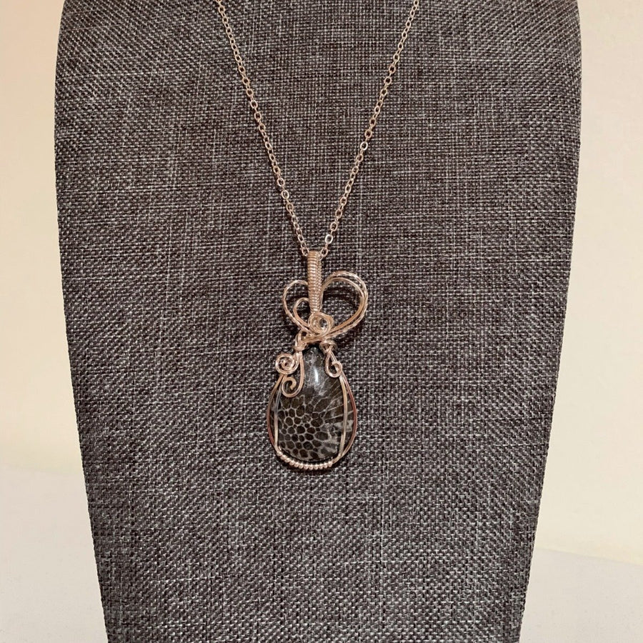 Pendant made of Natural Black Fossilized Coral stone with silver wrap; 7/8" w x 2" h, incl bail