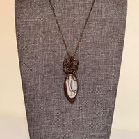 Pendant made of Brown & cream Botswana Agate with Vintage Bronze wrap; .75" w x 2.25" h, incl bail