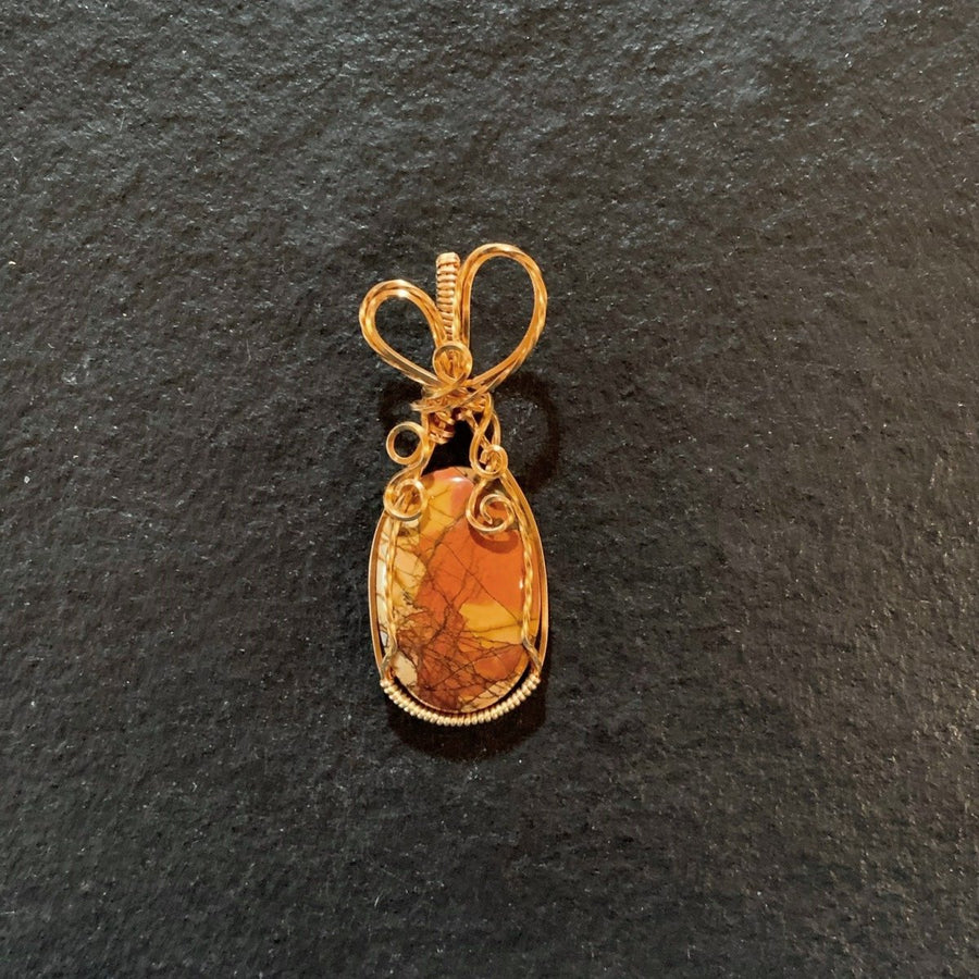 Pendant made of Red Creed Jasper Oval stone with gold wrap; 7/8" w x 2 1/8" h, incl bail