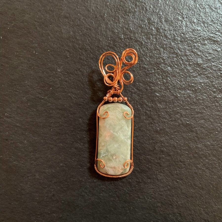 Pendant made of Large Light Green Serpentine Rectangle with hints of copper in copper wire wrap; 1"w x 3 1/8" h, incl bail