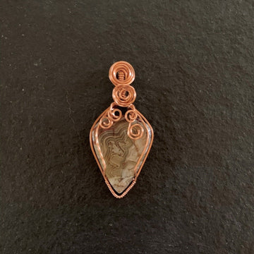 Pendant made of Crazy Lace Teardrop Agate with Copper wire wrap; 11/8" w x 2 3/8" long, incl bail