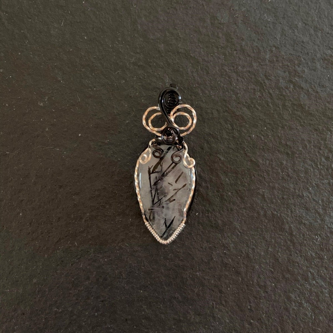 Pendant made of Black Rutilated Quartz Teardrop with black & silver wrap; 7/8" w x 2.25" long, incl bail