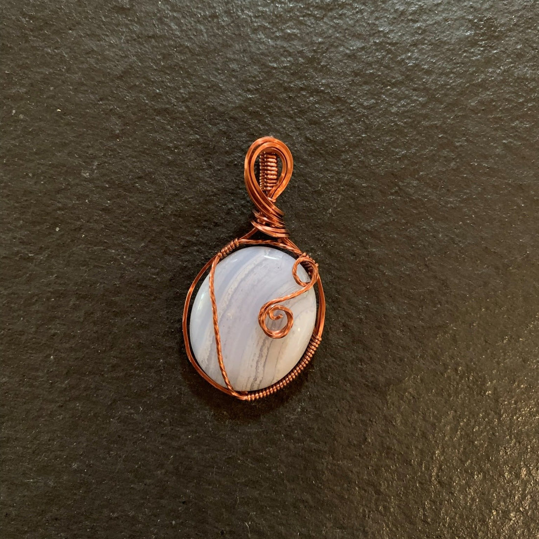 Pendant made of Blue Lace Agate Oval Stone with Antique Copper wire wrap; 1" w x 2 1/8" long incl bail