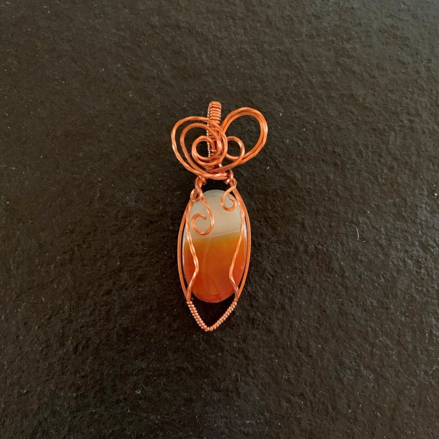 Pendant made of Montana Agate Oval with Copper wire wrap; .75" w x 1 1/8" long incl bail