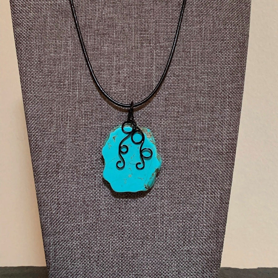 Pendant made of Turquoise Slab Nugget Pendant with black wire wrap & black cord; 1.25" w x 2" long incl bail