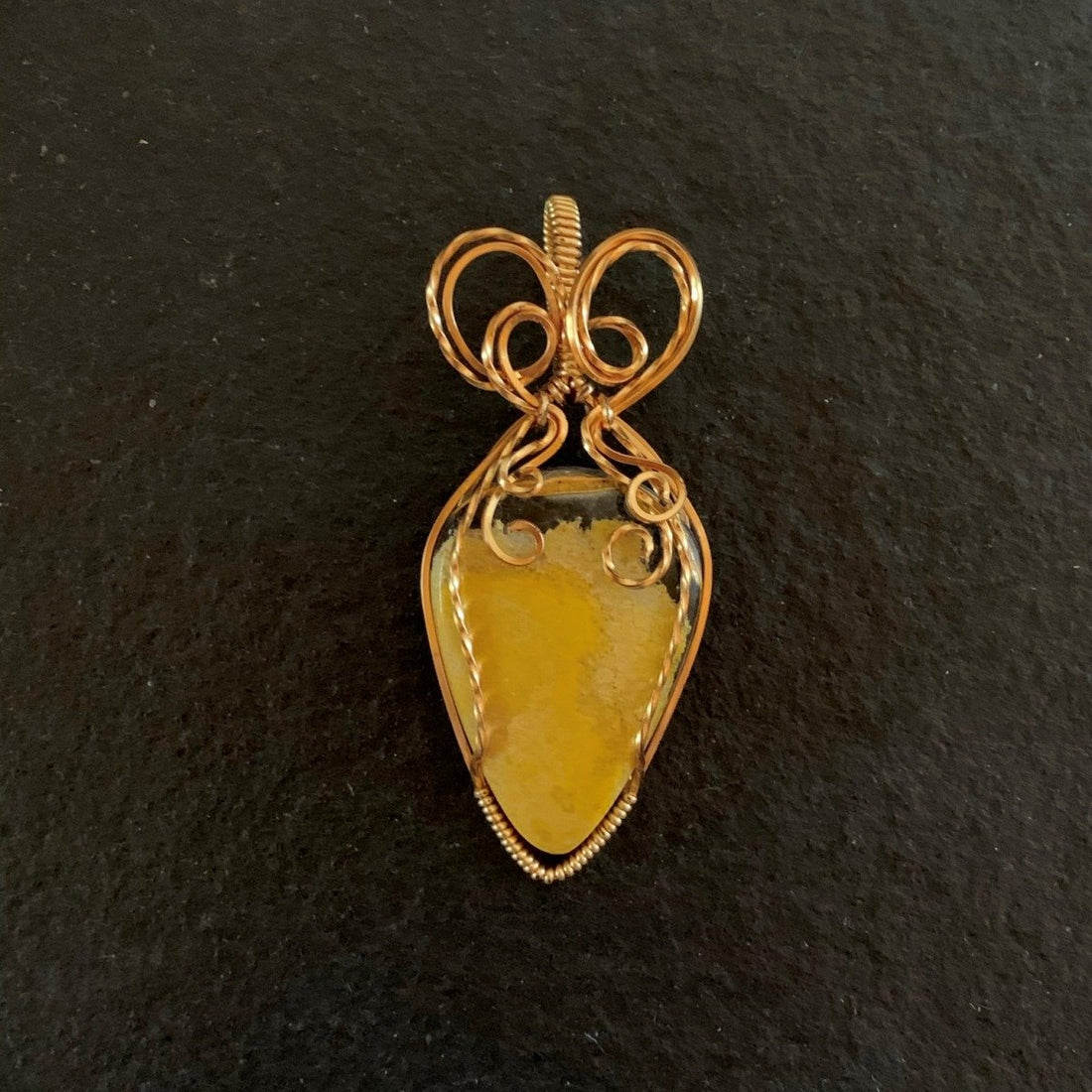 Pendant made of Bumble Bee Jasper Teardrop stone with gold wire wrap; 1"w x 2.5" long, incl bail