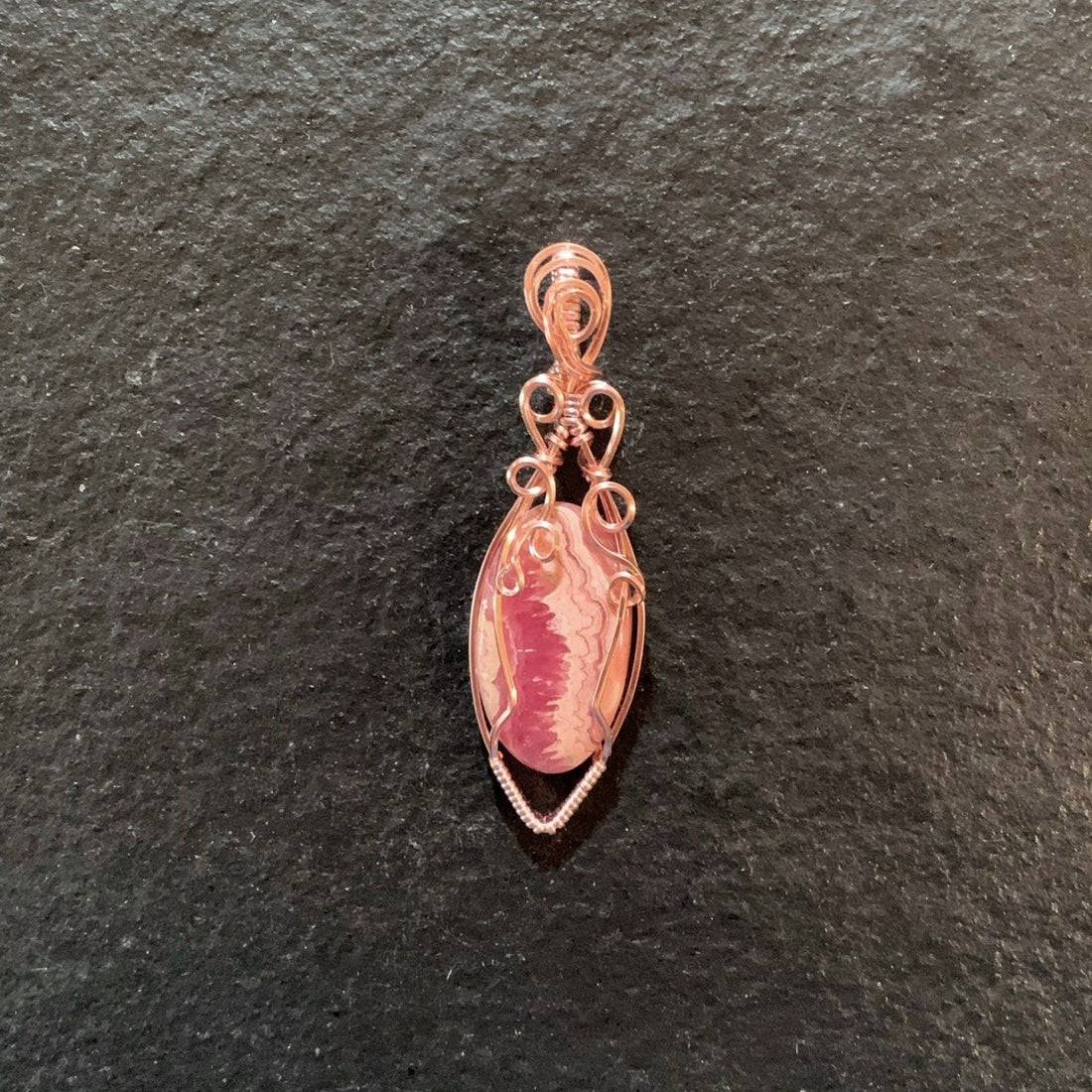 Pendant made of Rhodochrosite Oval stone with Rose Gold Wire Wrap; .75" w x 2.5" long, incl bail