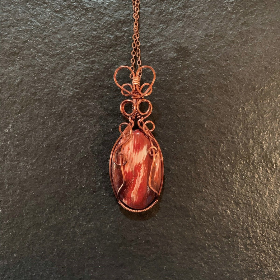 Pendant made of Snake Skin Jasper Oval with Antique Copper wire wrap; 1" w x 2 5/8" long, incl bail