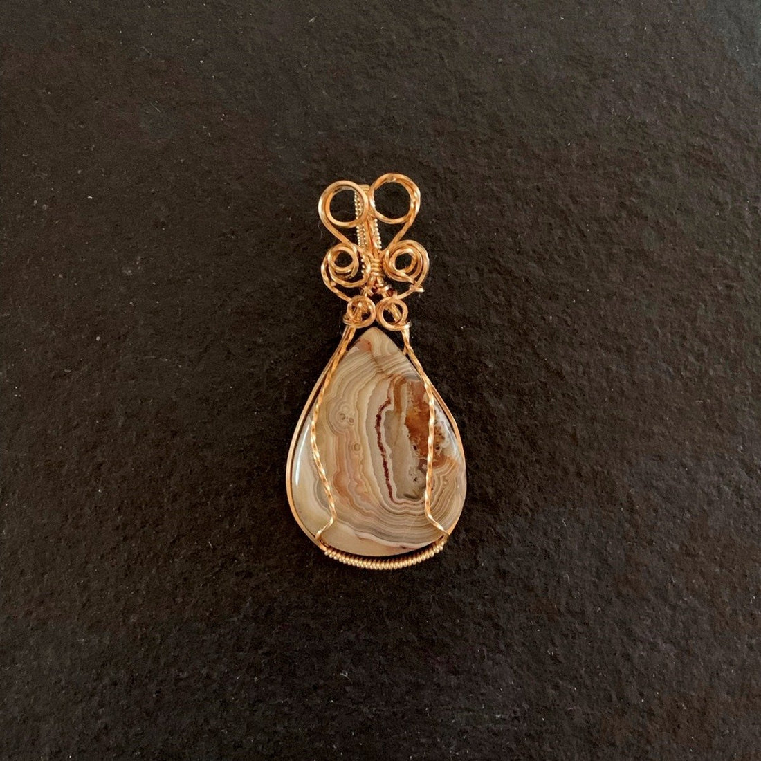 Pendant made of Crazy Lace Agate Teardrop Stone with Gold wire Wrap; 1.25" w x 2 5/8" long, incl bail