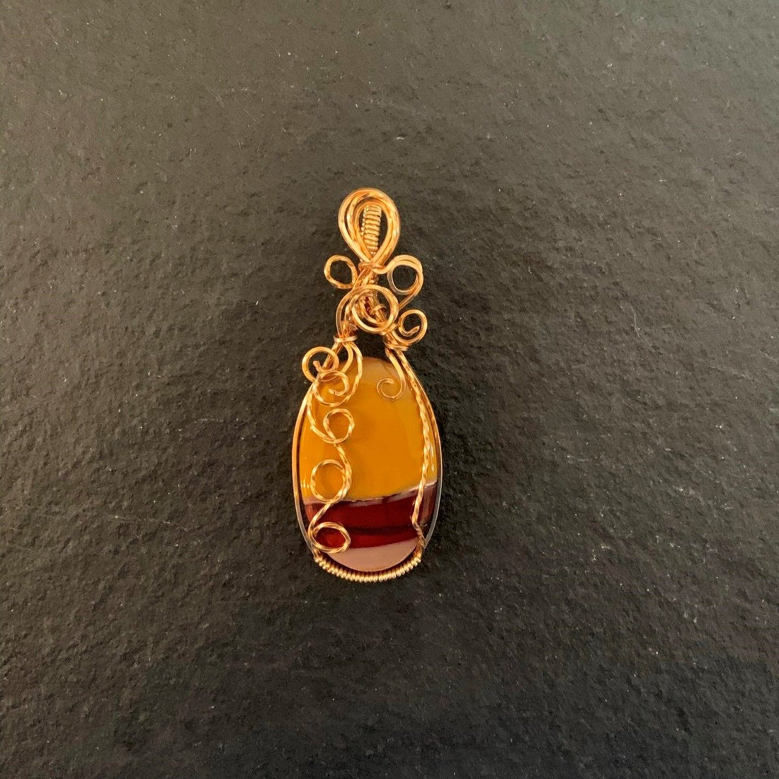 Pendant made of Mookaite Oval with gold wire wrap; 1"w x 25/8" long, incl bail