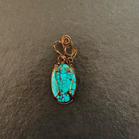 Pendant made of Turquoise oval Stone with bronze wire wrap; 7/8" w x 2.5" long incl bail