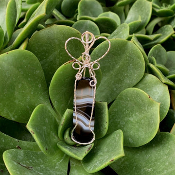 Pendant made of Black & White Banded Agate Rectangle with silver wire wrap; 1" w x 28/5" long, incl bail