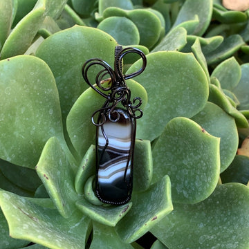 Pendant made of Black & White Banded Agate Rectangle with Black wire wrap; 1" w x 2.5" long