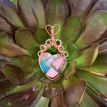 Mojave Turquoise Heart stone with Rose Gold & Antique Copper wire wrap; 1 1/8" w x 2 1/8" long incl bail  This stone has been regarded as a power stone bringing protection from accidents and good fortune.