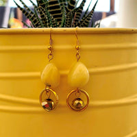 A jewelry set made of matching honey opals with gold rondels and gold beads; containing two bracelets and one pair of earrings